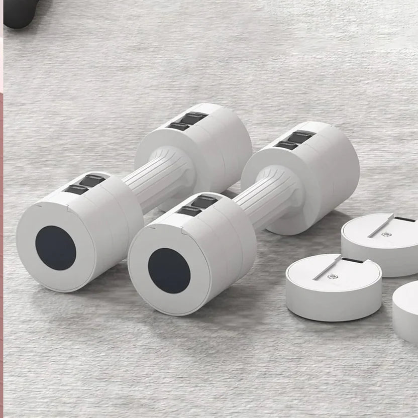 Set of white dumbbells with black circular ends on a gray surface