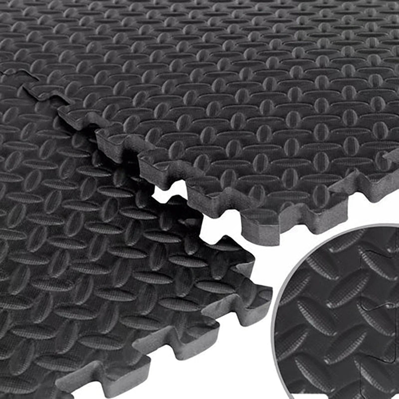 Stack of black interlocking foam mats with textured surface