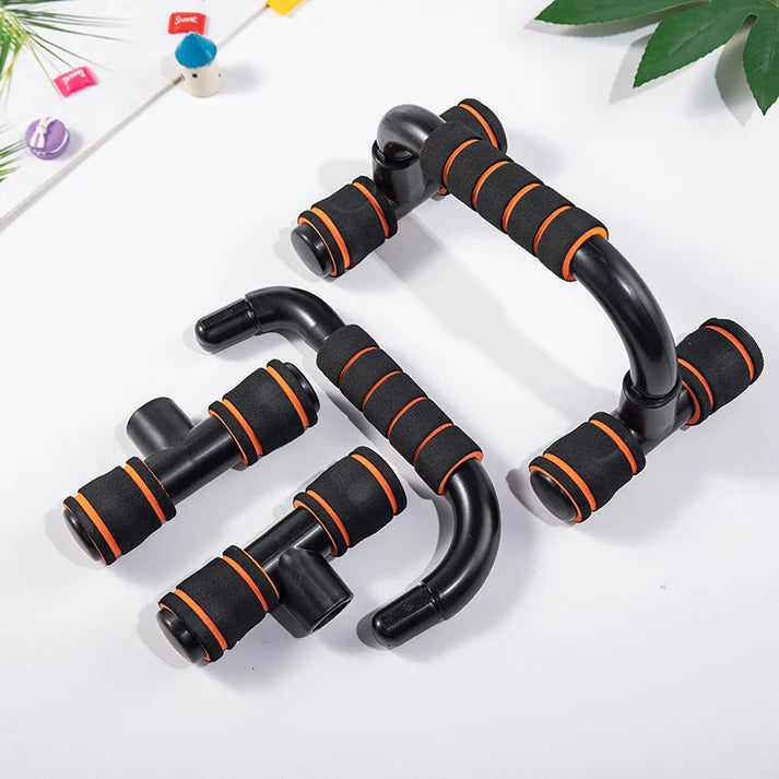 Black and orange exercise handles on a white background with green leaves.