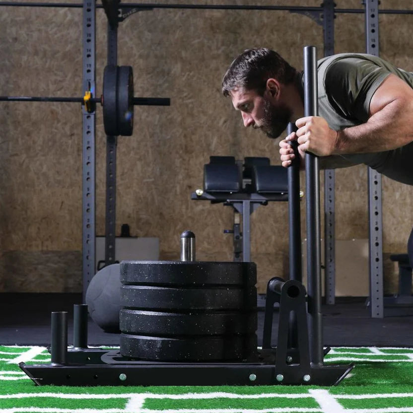 Man lifting weights on a squat rack in a gym setting