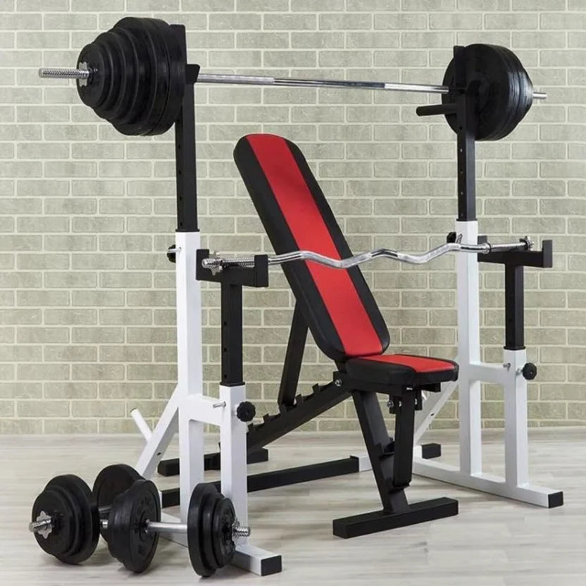 Weight bench with barbell and weights on a tiled floor.